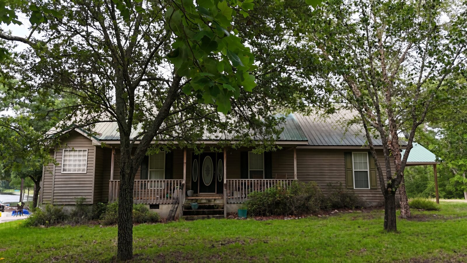 Ranch home with front porch and metal roof
